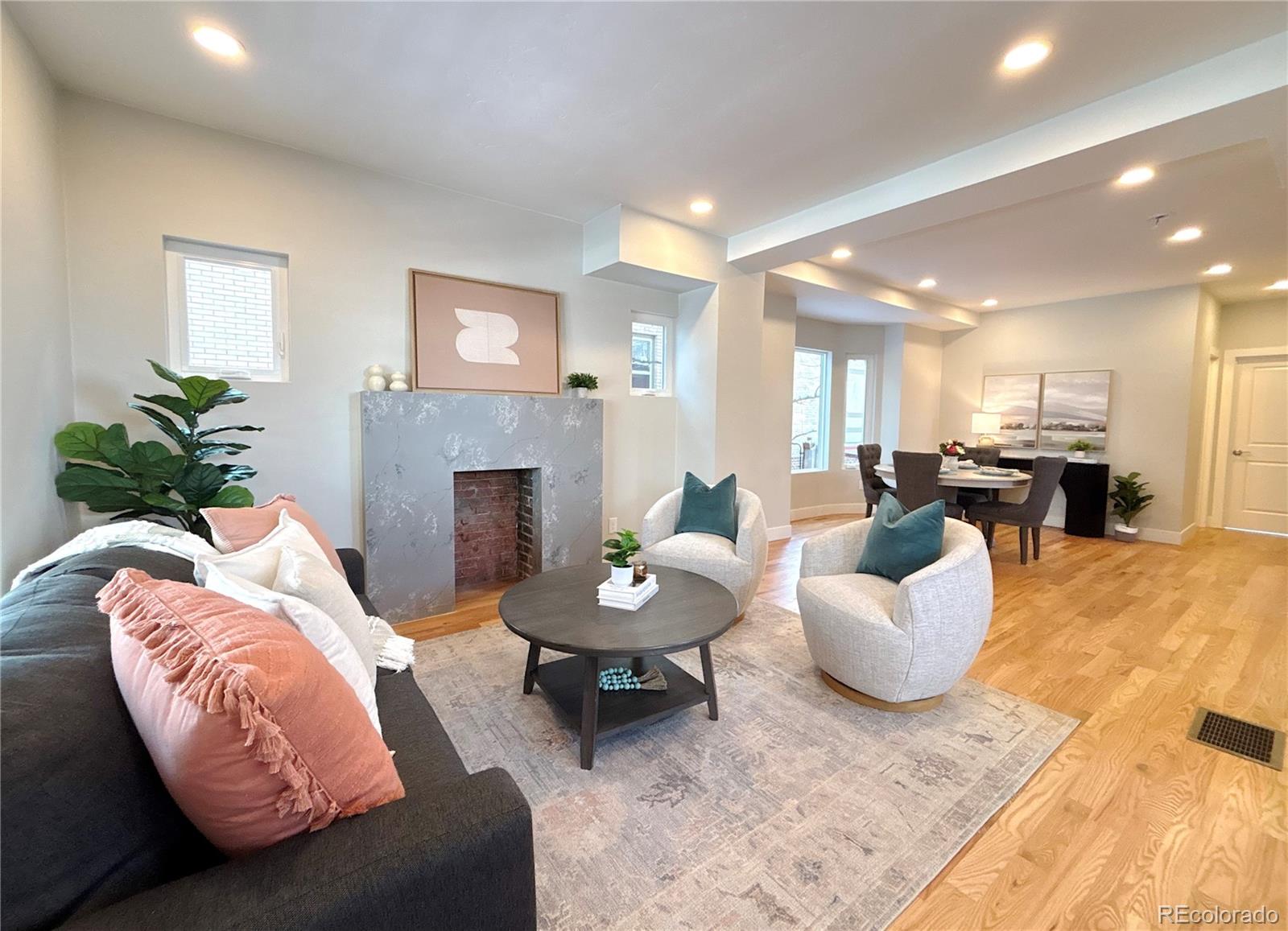1129 Fillmore Street Denver, CO 80206 - Photo 1 of 32 a living room with furniture and a fireplace