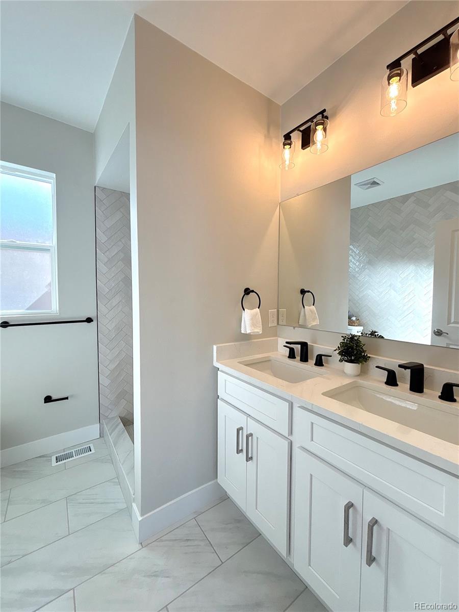 1129 Fillmore Street Denver, CO 80206 - Photo 16 of 32 a bathroom with a double vanity sink mirror and