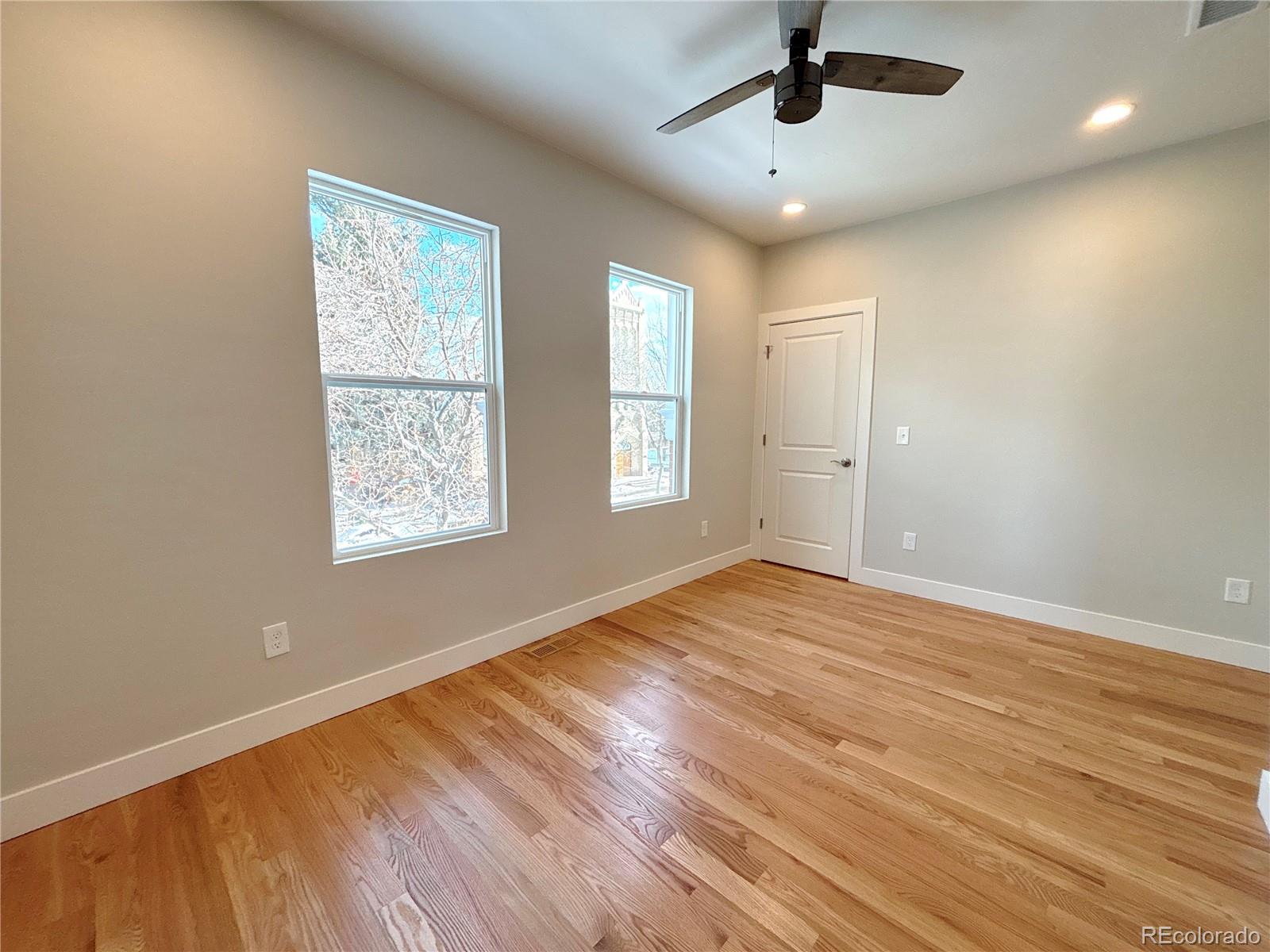 1129 Fillmore Street Denver, CO 80206 - Photo 19 of 32 wooden floor in an empty room with a window