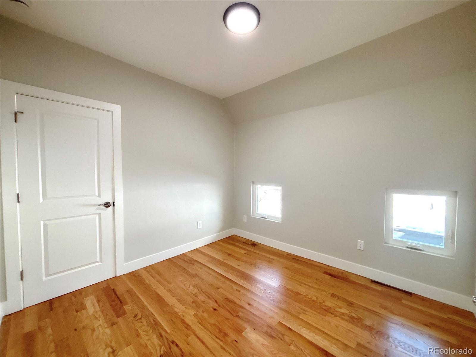 1129 Fillmore Street Denver, CO 80206 - Photo 20 of 32 a view of empty room with window and wooden floor