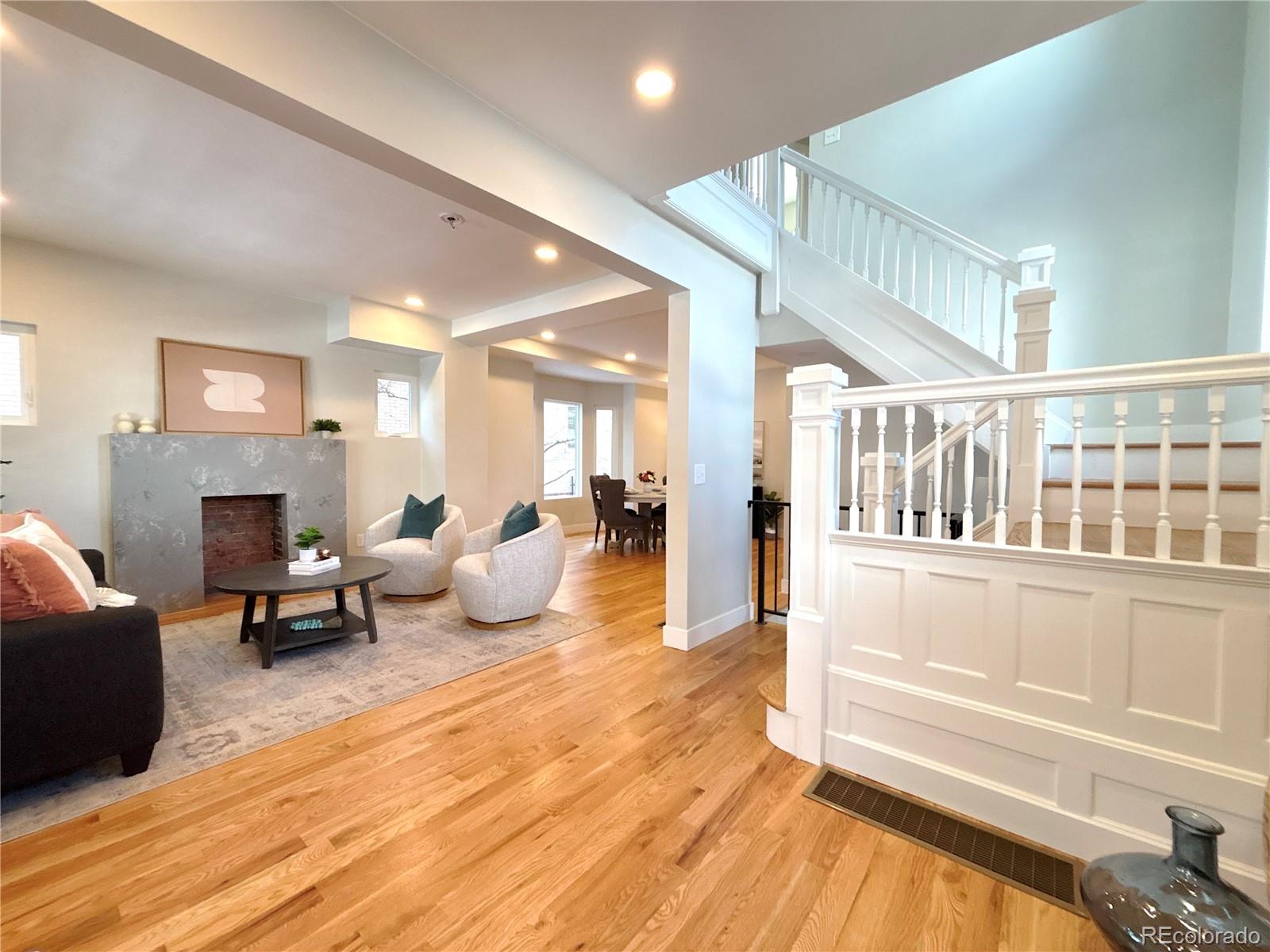 1129 Fillmore Street Denver, CO 80206 - Photo 2 of 32 a living room with furniture and a fireplace