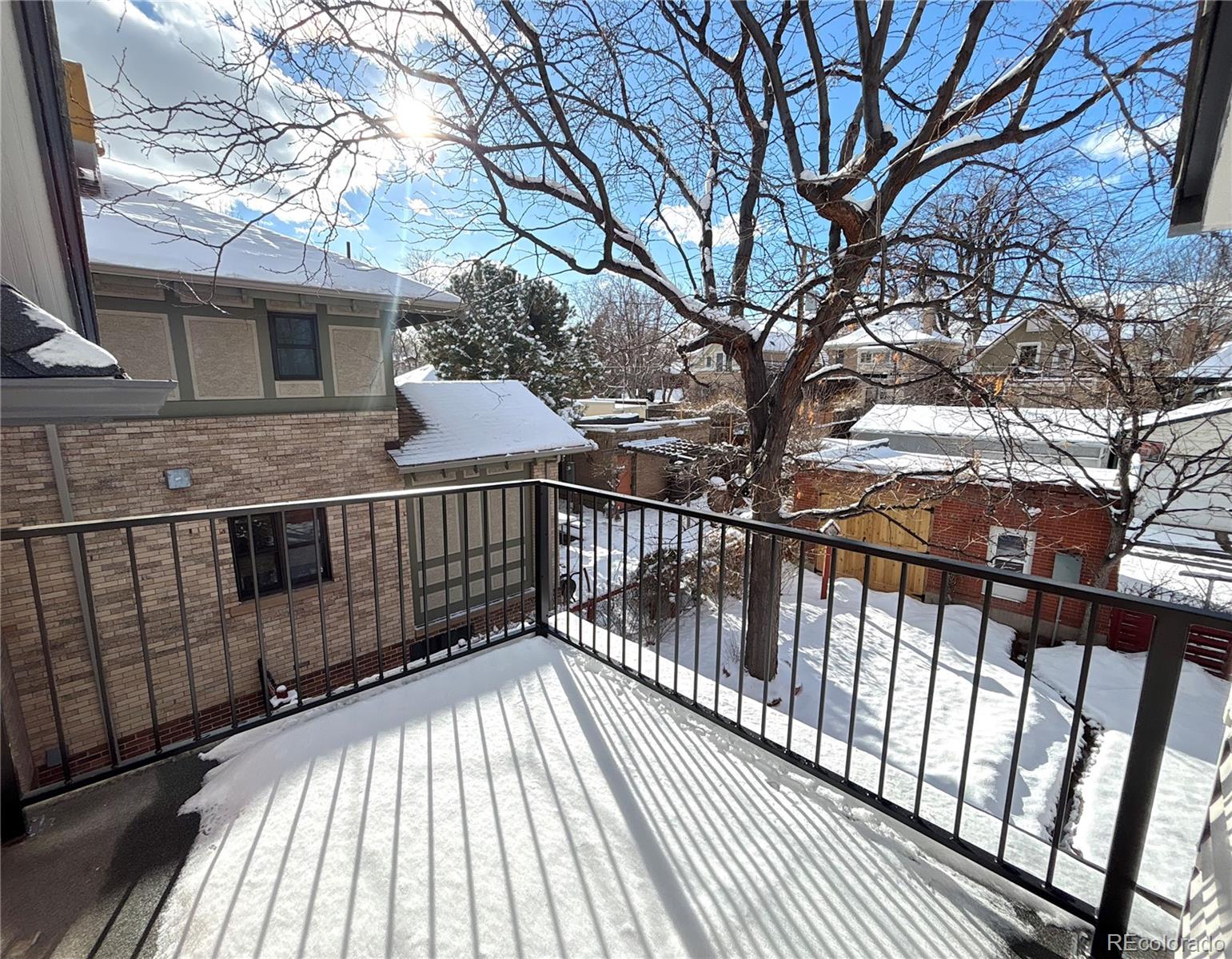 1129 Fillmore Street Denver, CO 80206 - Photo 22 of 32 a view of balcony with wooden floor and fence