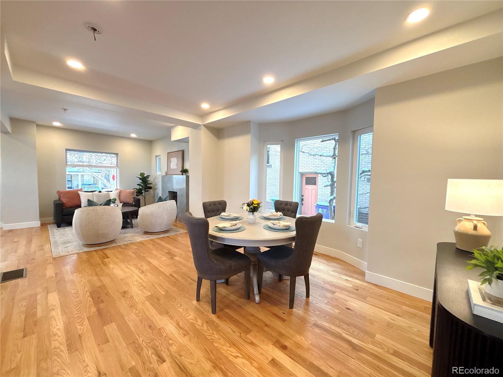 1129 Fillmore Street Denver, CO 80206 - Photo 5 of 32 a living room with furniture a wooden floor and a rug