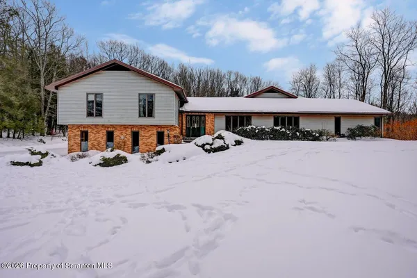 a view of a white house covered in snow