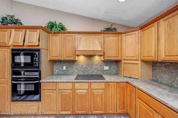 a large kitchen with stainless steel appliances granite countertop a large counter top and a stove