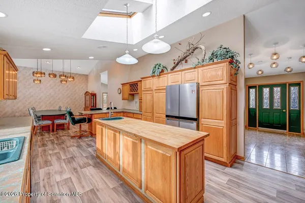 a kitchen with stainless steel appliances granite countertop a sink a stove and a refrigerator
