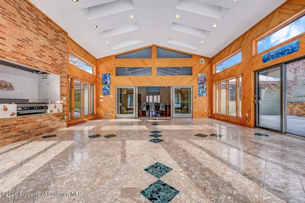 a view of an empty room with a fireplace and a large window