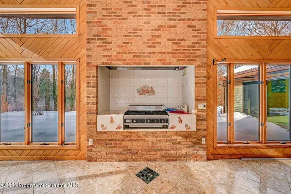 a view of an empty room with a fireplace and a window