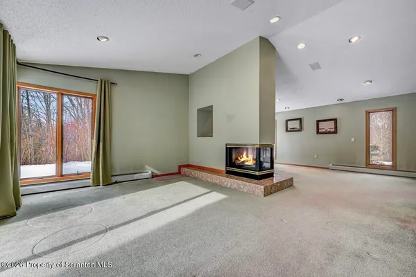 a living room with a bed and a window