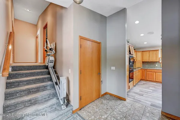 a living room with furniture a rug and white walls