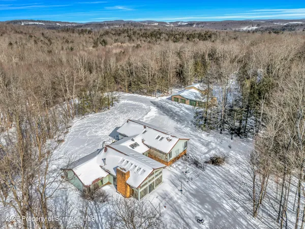 a kitchen with a stove a sink a center island and windows