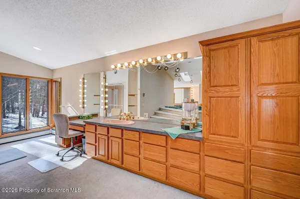 a view of a workspace with furniture