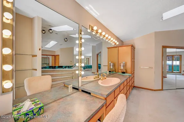 an empty room with a bathroom and a sink