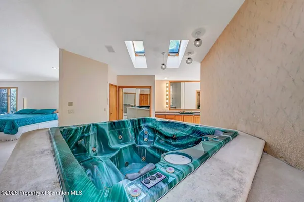 a view of a kitchen with stainless steel appliances granite countertop cabinets and a window