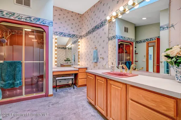 a view of a house with a yard covered in snow