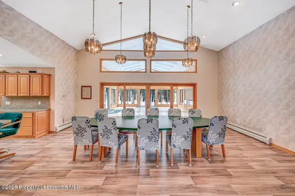 a view of a room with furniture and wooden floor