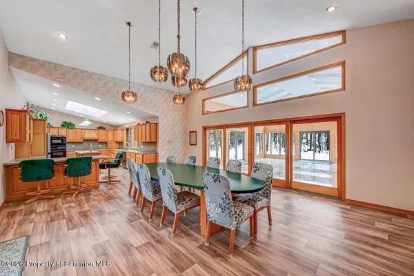 a kitchen with stainless steel appliances granite countertop a refrigerator a stove and a wooden floors