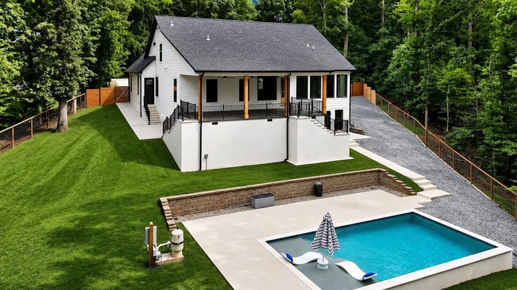 1422 Hunters Trail Anderson, SC 29625 - Photo 39 of 41 A modern residence with a private pool and spacious lawn, framed by a verdant forest. (some of the grass is virtual)