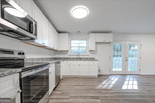 a kitchen with granite countertop a stove and a sink