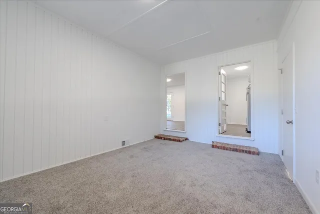 an empty room with large windows