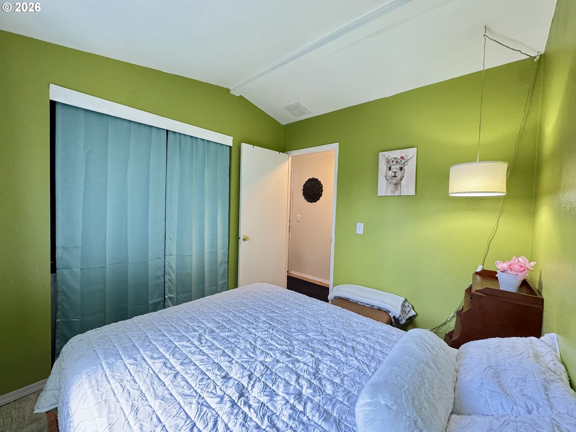 3760 Highway 101, Unit 1 Florence, OR 97439 - Photo 12 of 32 a bedroom with a bed and a painting on the wall