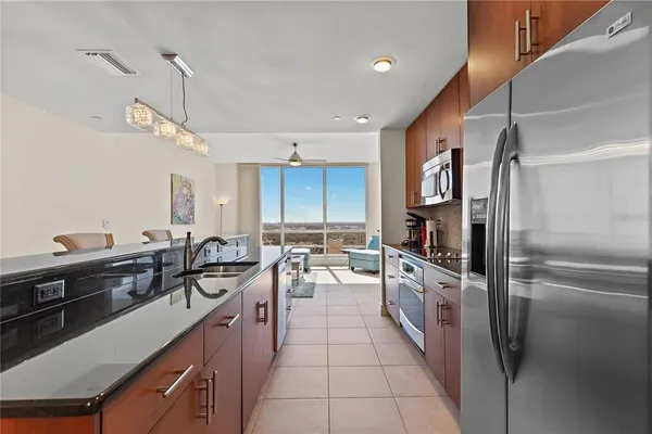 a kitchen with stainless steel appliances a sink stove and refrigerator