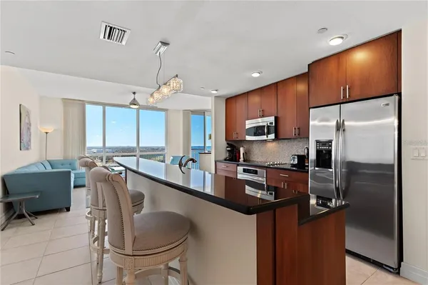 a kitchen with stainless steel appliances a sink stove and refrigerator