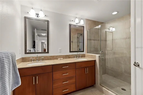 a bathroom with a granite countertop sink mirror and double