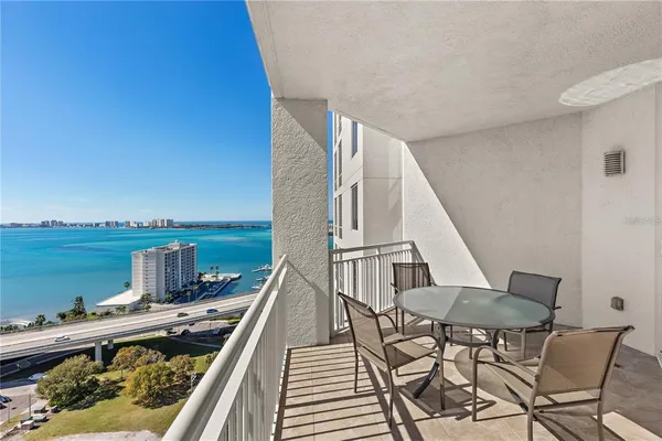a view of a chairs and table in balcony