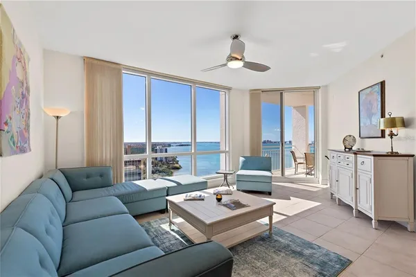 a living room with furniture and large windows