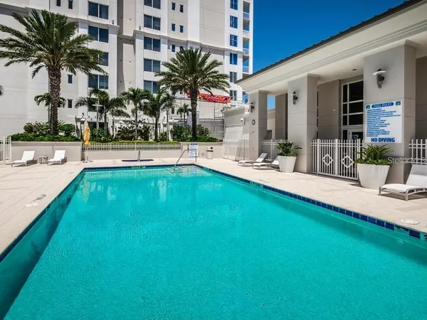a swimming pool with outdoor seating and yard
