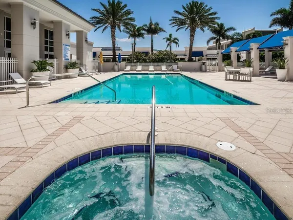 a swimming pool with outdoor seating and yard