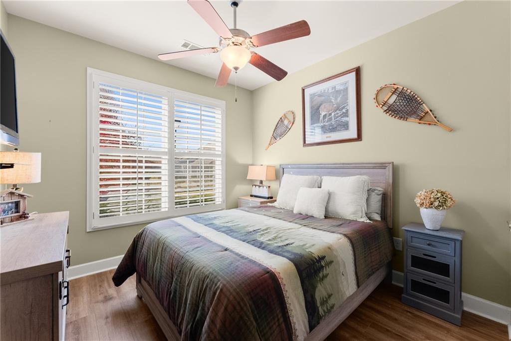 3476 Locust Cove Road Gainesville, GA 30504 - Photo 16 of 71 a bedroom with a bed and a chandelier