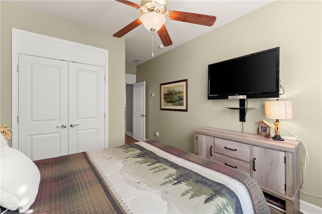 3476 Locust Cove Road Gainesville, GA 30504 - Photo 17 of 71 a bedroom with a bed and a flat screen tv