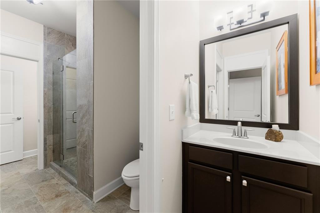 3476 Locust Cove Road Gainesville, GA 30504 - Photo 19 of 71 a bathroom with a sink vanity toilet and shower