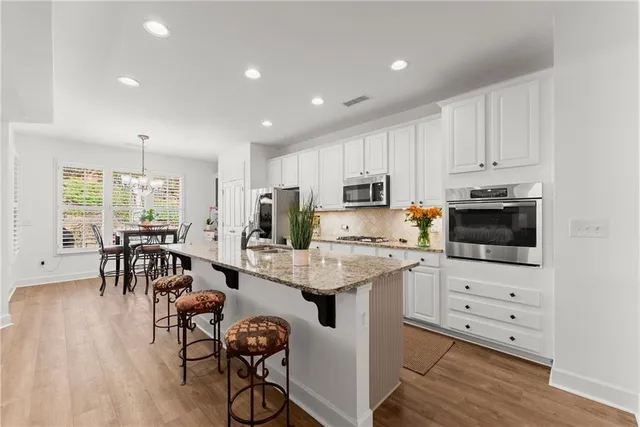 a view of kitchen with cabinets table and chairs