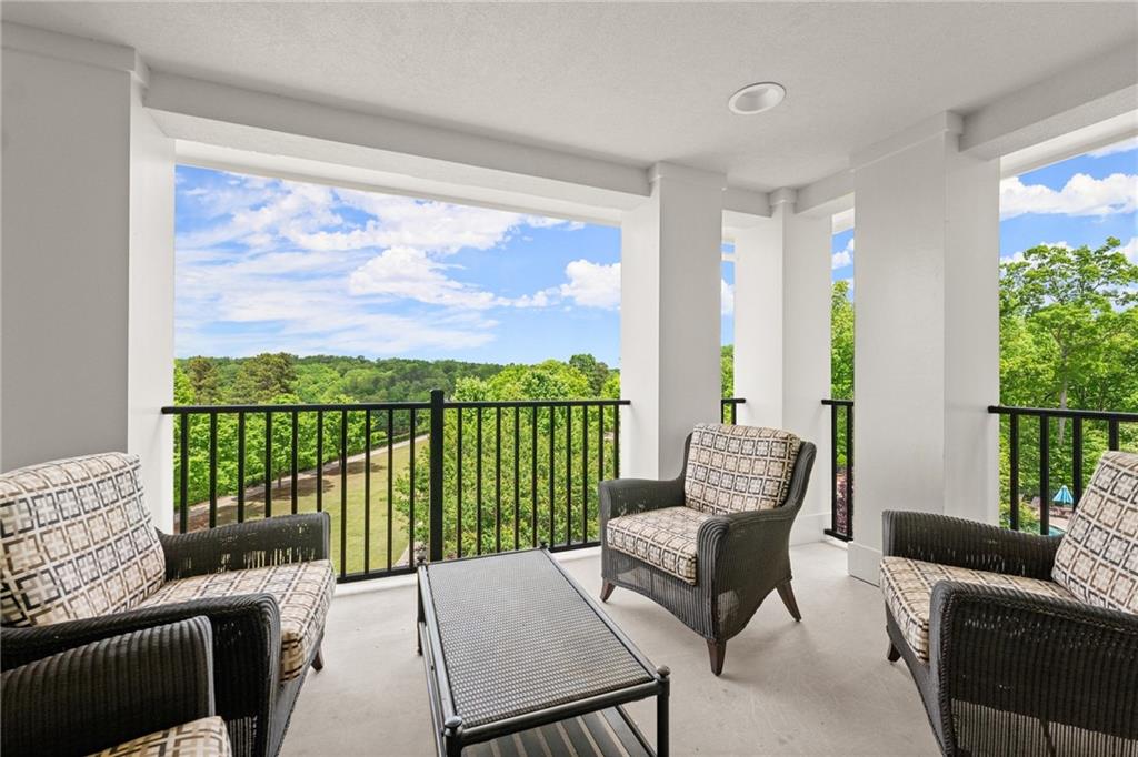 3476 Locust Cove Road Gainesville, GA 30504 - Photo 52 of 71 a living room with furniture tv and a floor to ceiling window