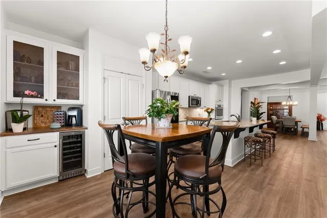 a view of a dining room with furniture wooden floor and chandelier