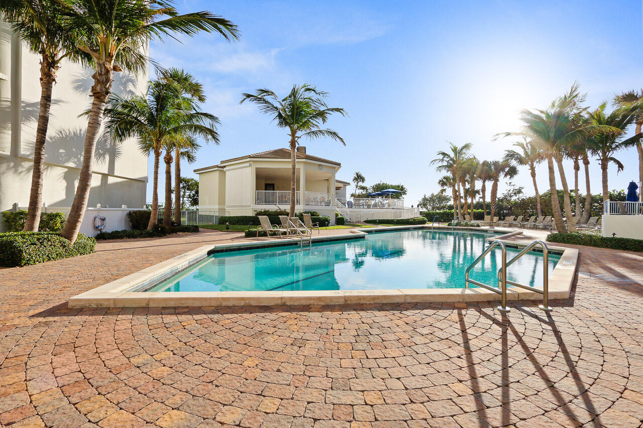 3000 North Ocean Drive, Unit 17D Riviera Beach, FL 33404 - Photo 24 of 34 a front view of a house with swimming pool and outdoor seating