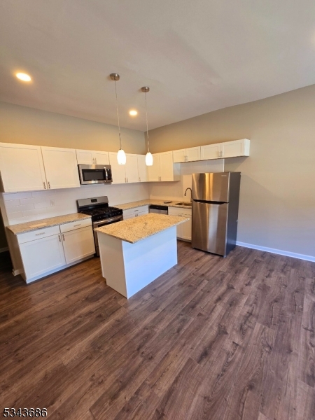 308 North 2nd Street Harrison, NJ 07029 - Photo 4 of 10 a large kitchen with kitchen island a stove a refrigerator a sink dishwasher a oven with wooden cabinets and floor