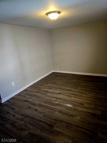 308 North 2nd Street Harrison, NJ 07029 - Photo 8 of 10 a view of an empty room with wooden floor and a window