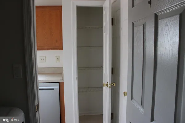 an empty room with wooden floor and entrance