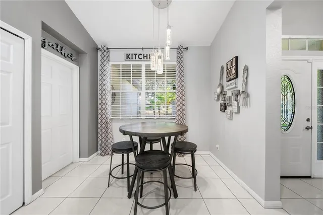 a dining room with furniture and window