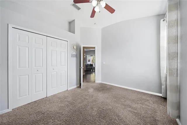 a view of a livingroom with a ceiling fan and window