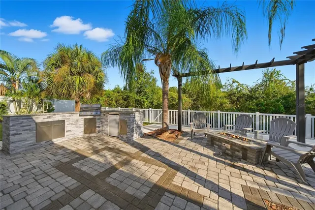 a view of a chair and tables in the patio