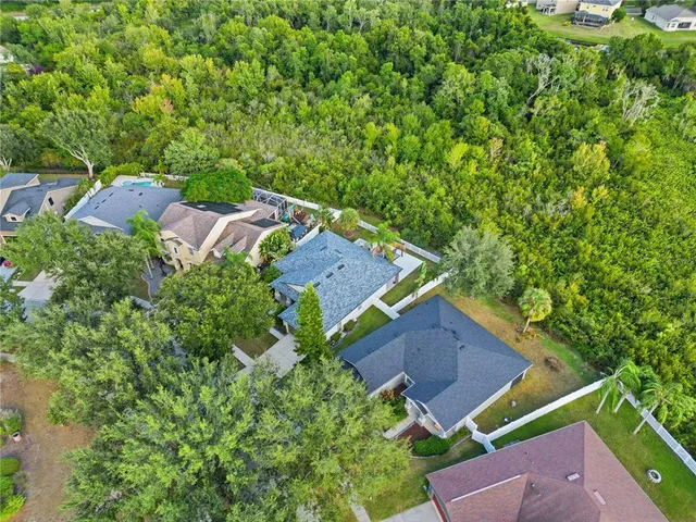 an aerial view of a house with garden space and street view