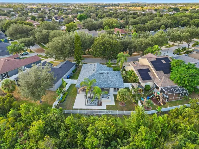 aerial view of a house with garden space and street view