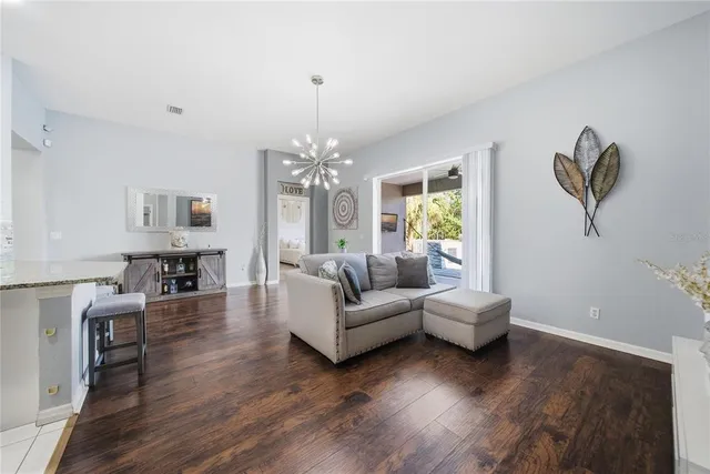 a living room with furniture and a chandelier