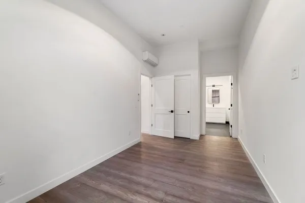 a view of an empty room and wooden floor