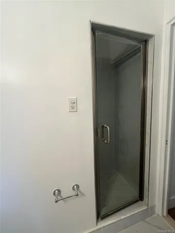 a bathroom with a glass shower door